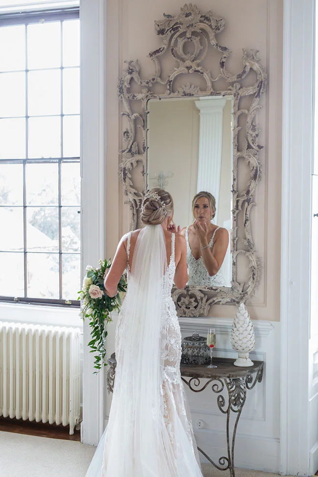 Bride applying make up in the mirror Molteno Couture designer bridal cape town bride wedding