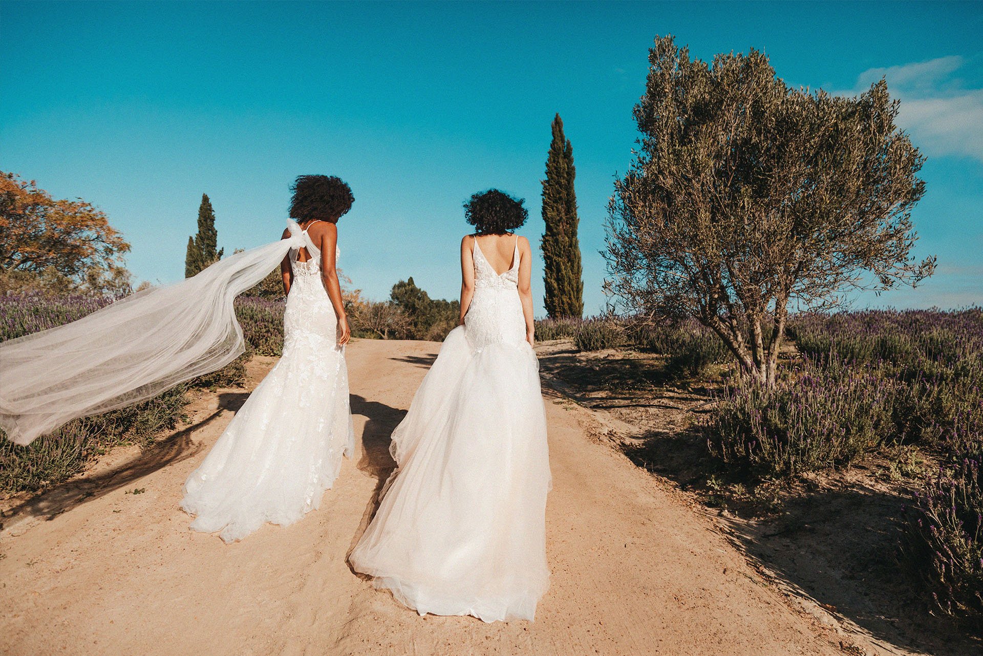 Two brides walking outside Molteno Couture designer bridal cape town outdoor wedding long veil